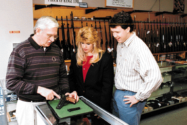 Gunstore clerk, woman and man.